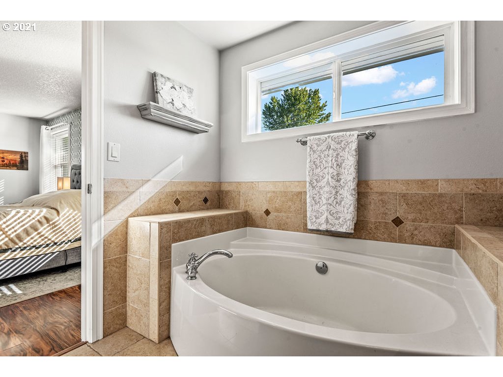 320 Northwest 194th Street Ridgefield, WA 98642 - Photo 23 of 32 a bathroom with a tub sink and view of living room