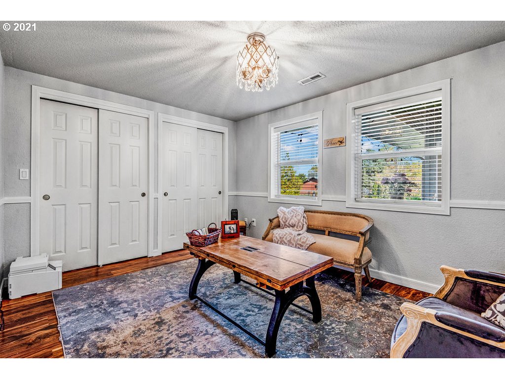 320 Northwest 194th Street Ridgefield, WA 98642 - Photo 25 of 32 a living room with furniture and a chandelier