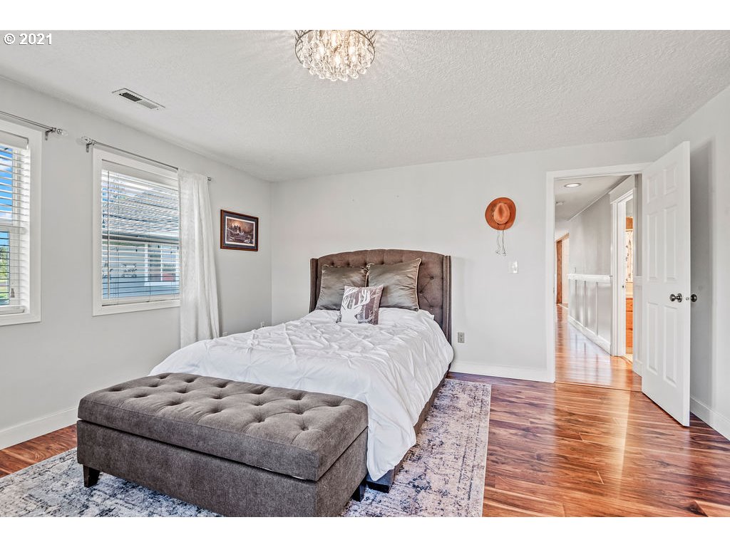 320 Northwest 194th Street Ridgefield, WA 98642 - Photo 27 of 32 a bedroom with a bed and wooden floor