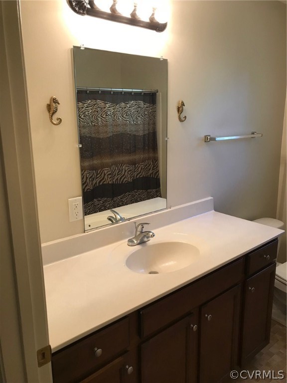 8855 Strath Road Henrico, VA 23231 - Photo 11 of 23 a bathroom with a sink vanity and a mirror