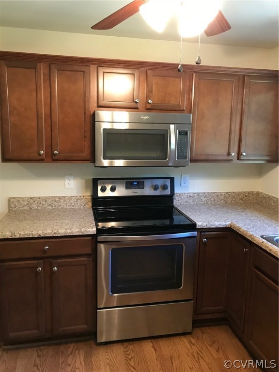 8855 Strath Road Henrico, VA 23231 - Photo 3 of 23 a kitchen with wooden cabinets and a stove top oven