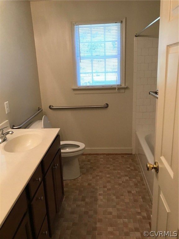 8855 Strath Road Henrico, VA 23231 - Photo 8 of 23 a bathroom with a sink a toilet and a mirror