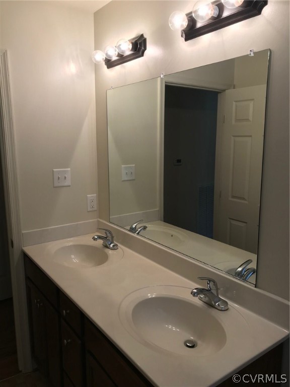 8855 Strath Road Henrico, VA 23231 - Photo 9 of 23 a bathroom with a sink and a mirror