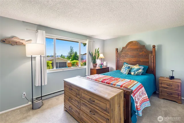 a bedroom with a bed and a potted plant