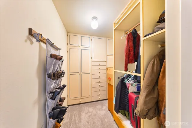 an empty room with a ceiling fan and window