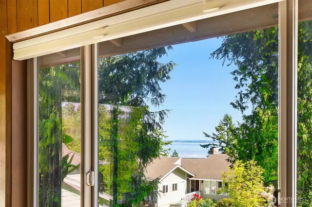 a view of a house with a tree front of it