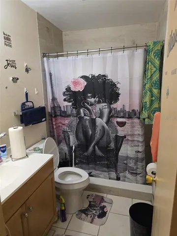 a bathroom with a toilet a sink and a shower