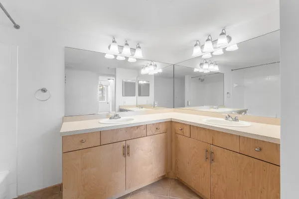 a spacious bathroom with a double vanity sink and a mirror