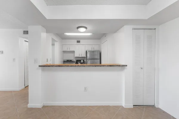 a kitchen with stainless steel appliances a refrigerator and a stove top oven