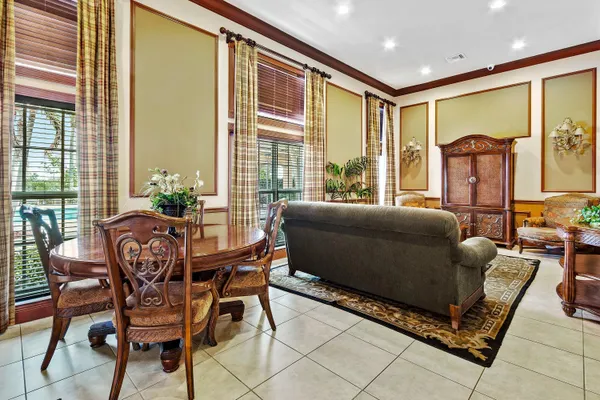 a living room with furniture and a floor to ceiling window