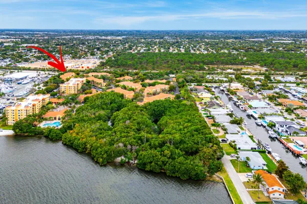 an aerial view of residential houses with outdoor space and trees