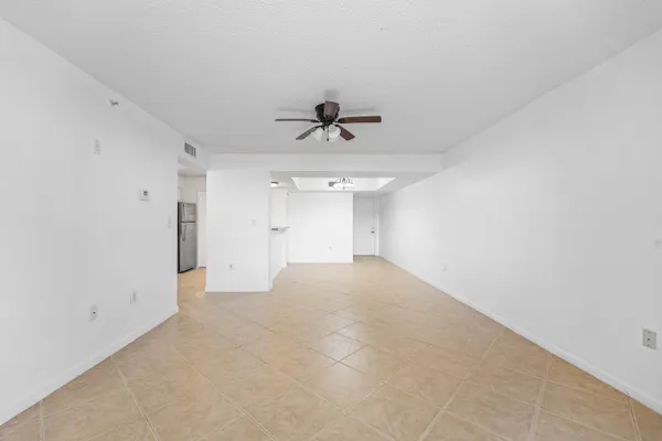 wooden floor in an empty room with a ceiling fan
