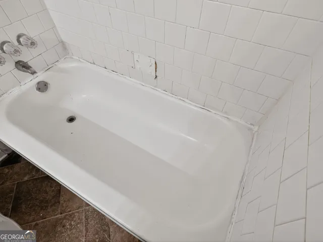 a bathroom with a white bathtub