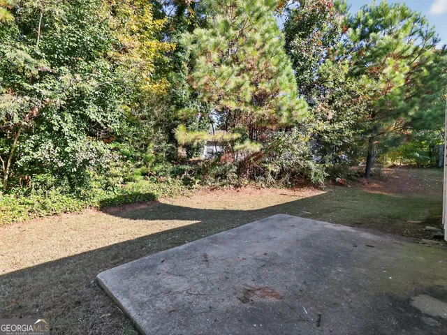 a view of a yard with large trees