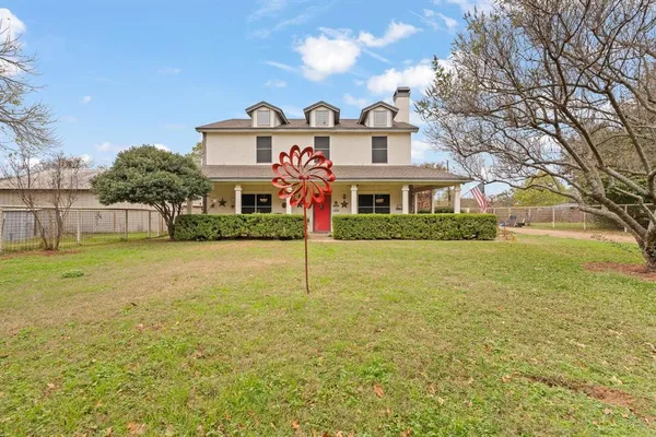 a front view of house with yard and green space
