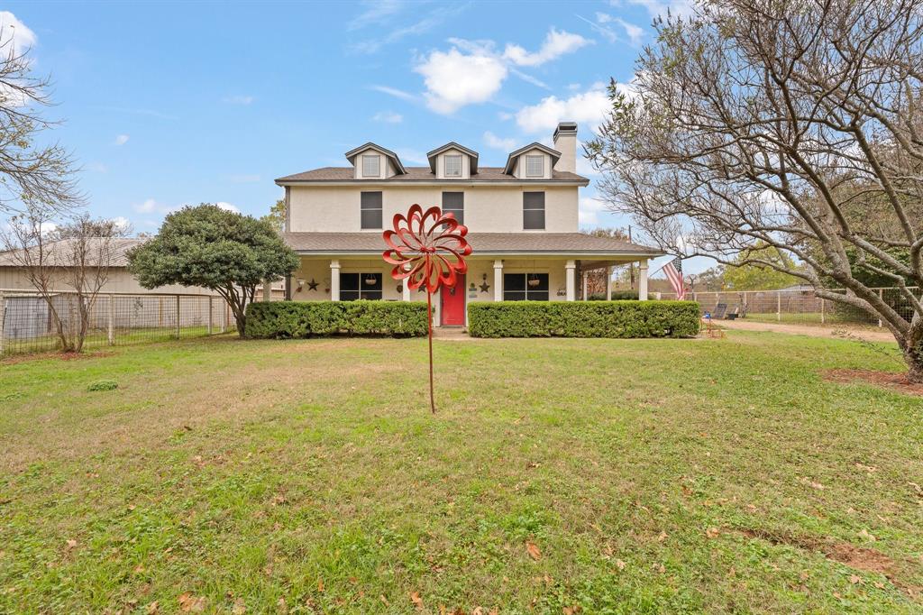 a front view of house with yard and green space