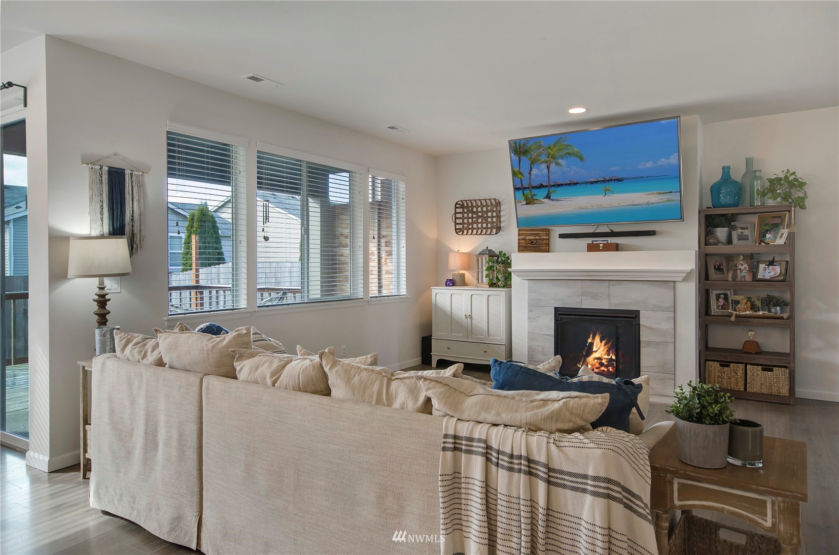 20206 18th Ave Court East Spanaway, WA 98387 - Photo 14 of 37 a living room with furniture a flat screen tv and a fireplace