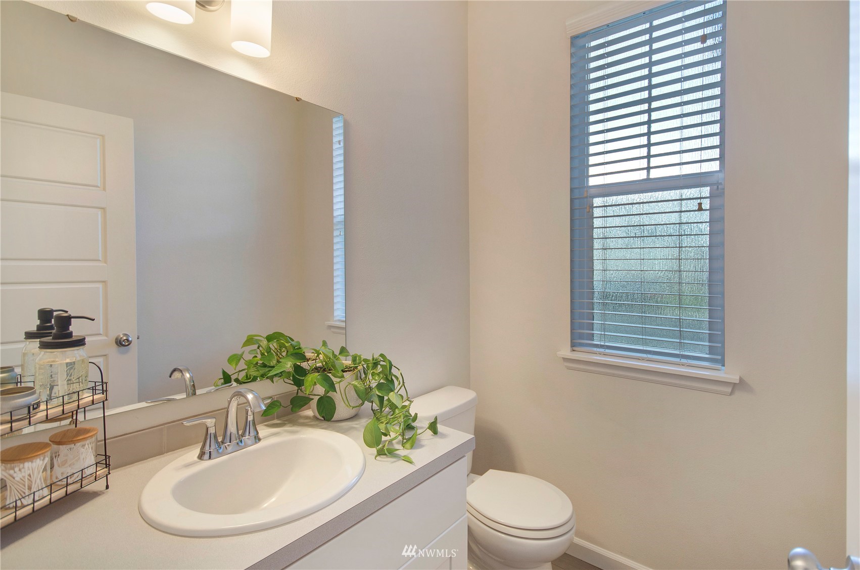20206 18th Ave Court East Spanaway, WA 98387 - Photo 15 of 37 a bathroom with a sink a toilet and a mirror
