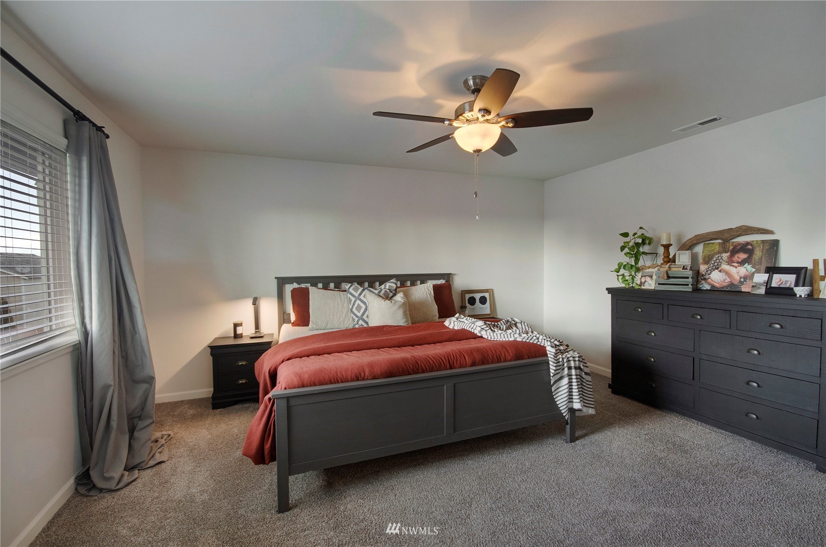 20206 18th Ave Court East Spanaway, WA 98387 - Photo 16 of 37 a bedroom with a bed and ceiling fan