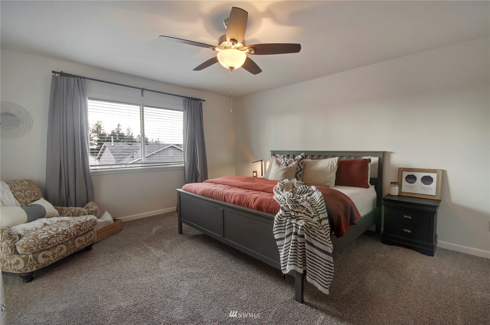 20206 18th Ave Court East Spanaway, WA 98387 - Photo 17 of 37 a bedroom with a bed and a chandelier
