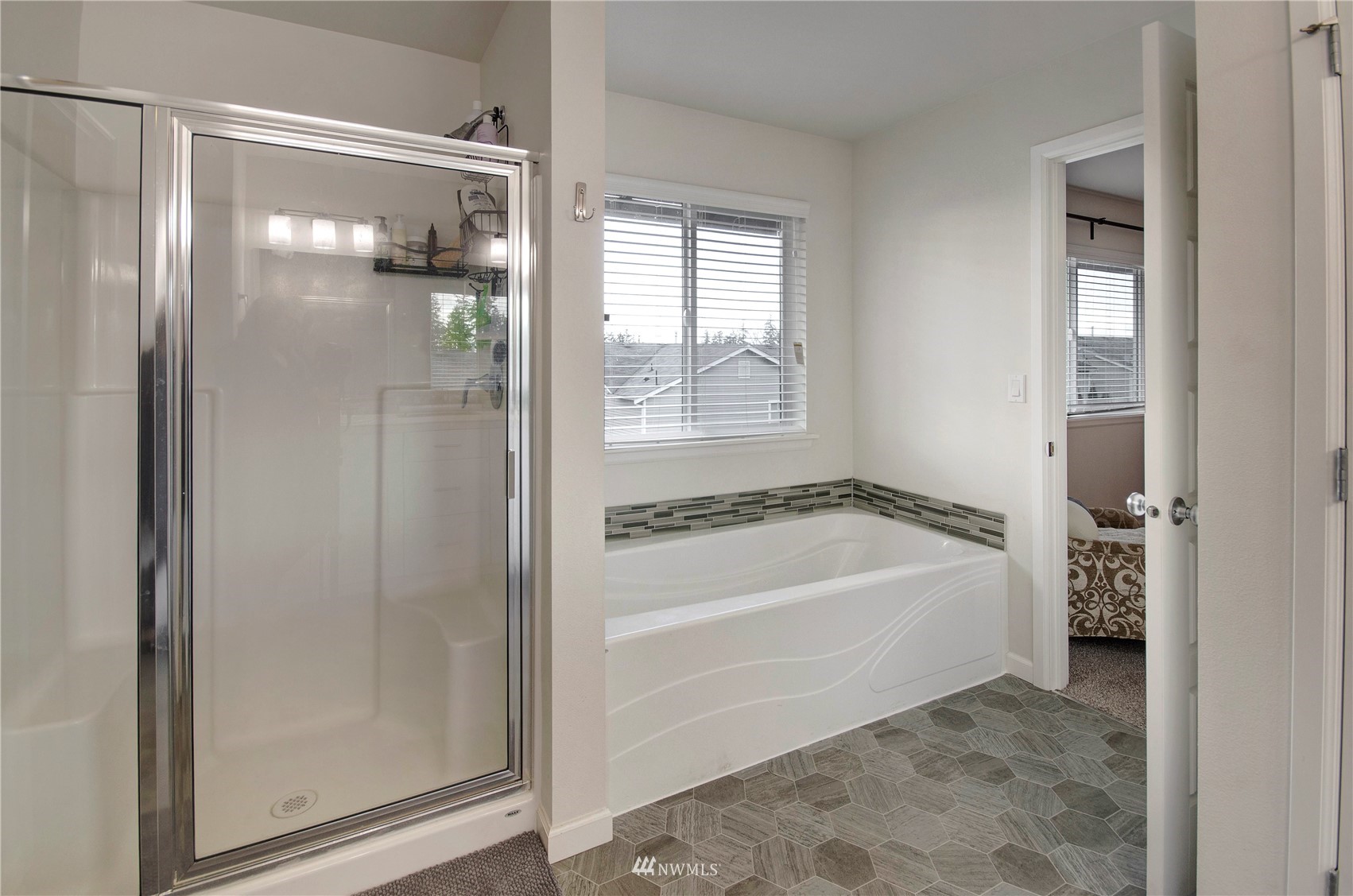 20206 18th Ave Court East Spanaway, WA 98387 - Photo 21 of 37 a bathroom with a tub shower and sink