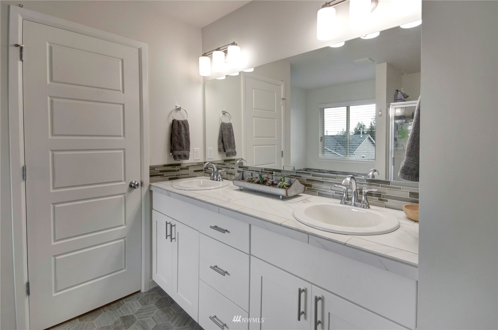 20206 18th Ave Court East Spanaway, WA 98387 - Photo 22 of 37 a bathroom with a double vanity sink and mirror