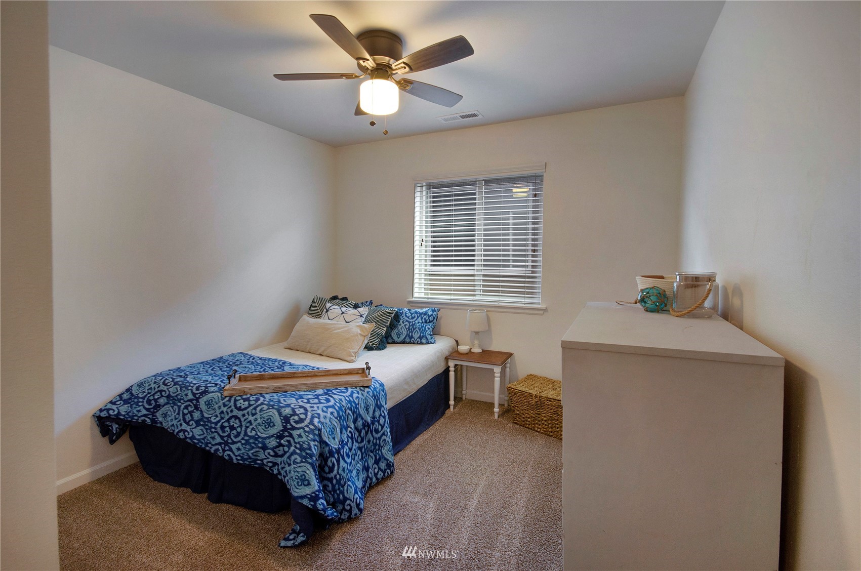 20206 18th Ave Court East Spanaway, WA 98387 - Photo 23 of 37 a bedroom with a bed and a chandelier