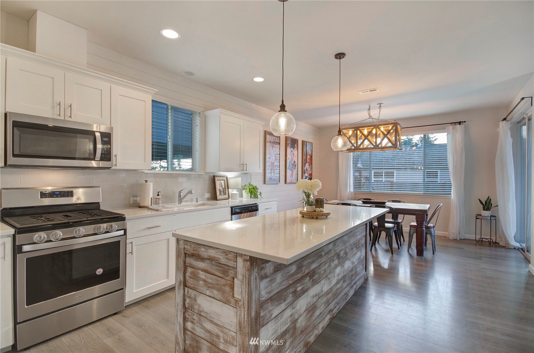 20206 18th Ave Court East Spanaway, WA 98387 - Photo 6 of 37 a kitchen with a stove and a wooden floor