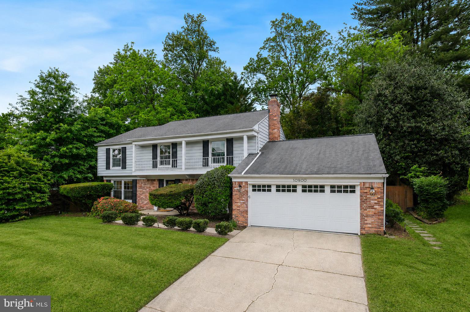 10900 Gainsborough Road Potomac, MD 20854 - Photo 40 of 44 a front view of house with yard and green space