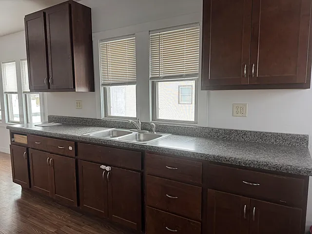 a kitchen with a sink cabinets and window