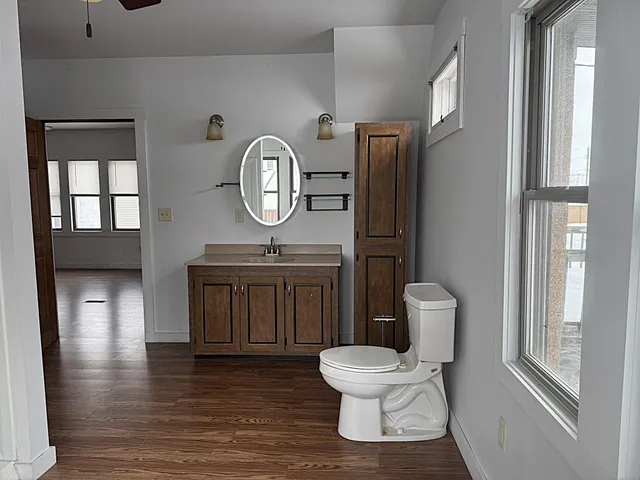 a bathroom with a toilet sink and mirror