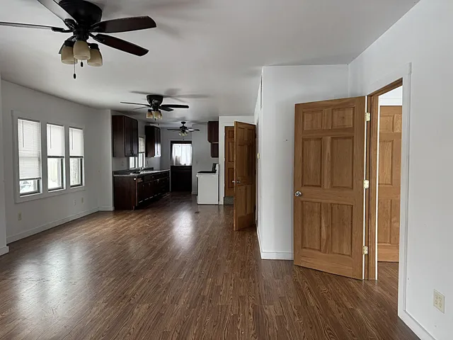 a view of a livingroom with hardwood floor and a ceiling fan