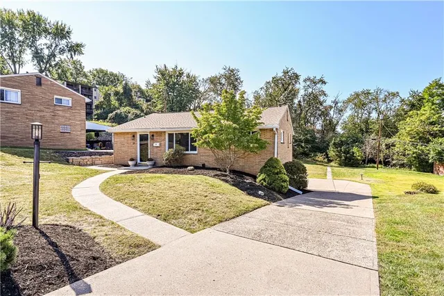 a house with swimming pool in front of it