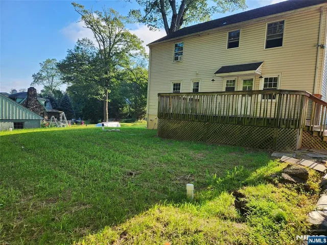 a view of a house with a yard and a garden