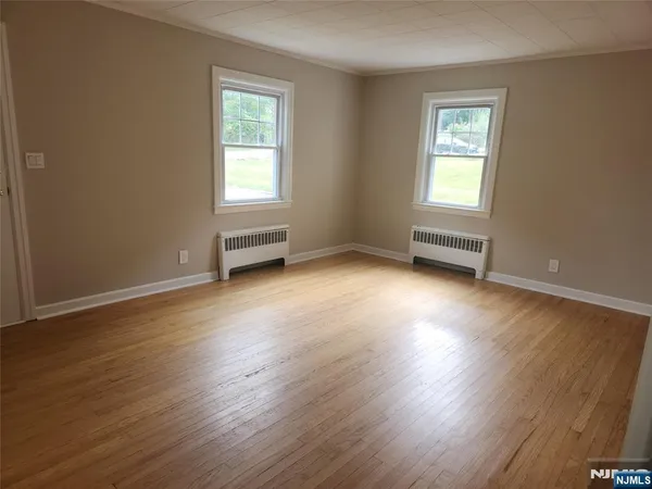 a kitchen with granite countertop white cabinets and a stove