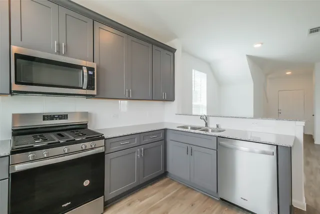 a kitchen with appliances cabinets and a sink