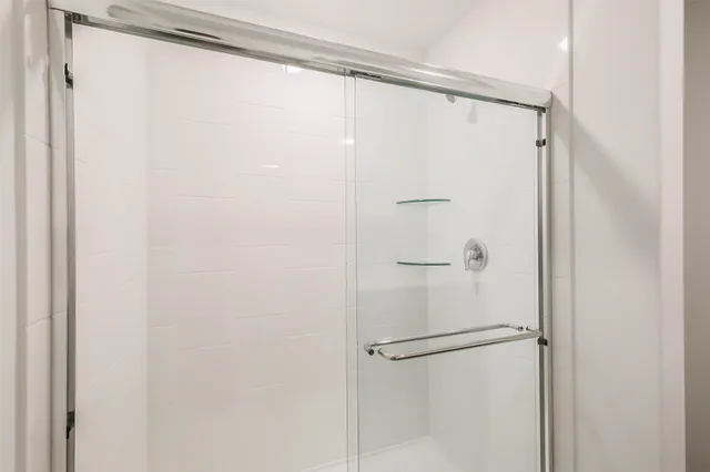 a bathroom with a glass shower door