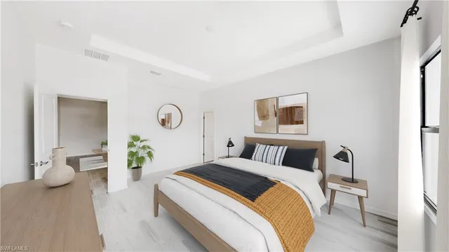 a bedroom with a bed and painting on the wall