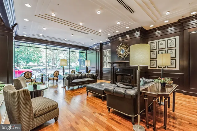 a living room with fireplace furniture and a large window