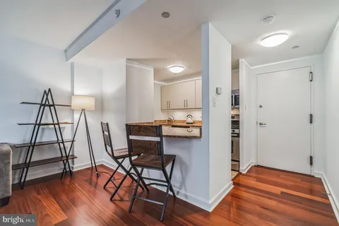 a view of a workspace with furniture and wooden floor