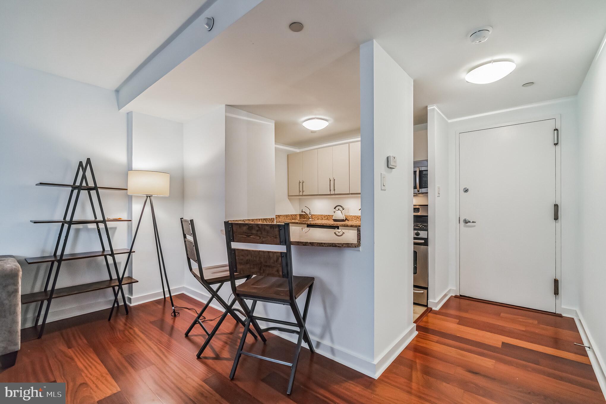 219 South 18th Street, Unit 1105 Philadelphia, PA 19103 - Photo 3 of 15 a view of a workspace with furniture and wooden floor