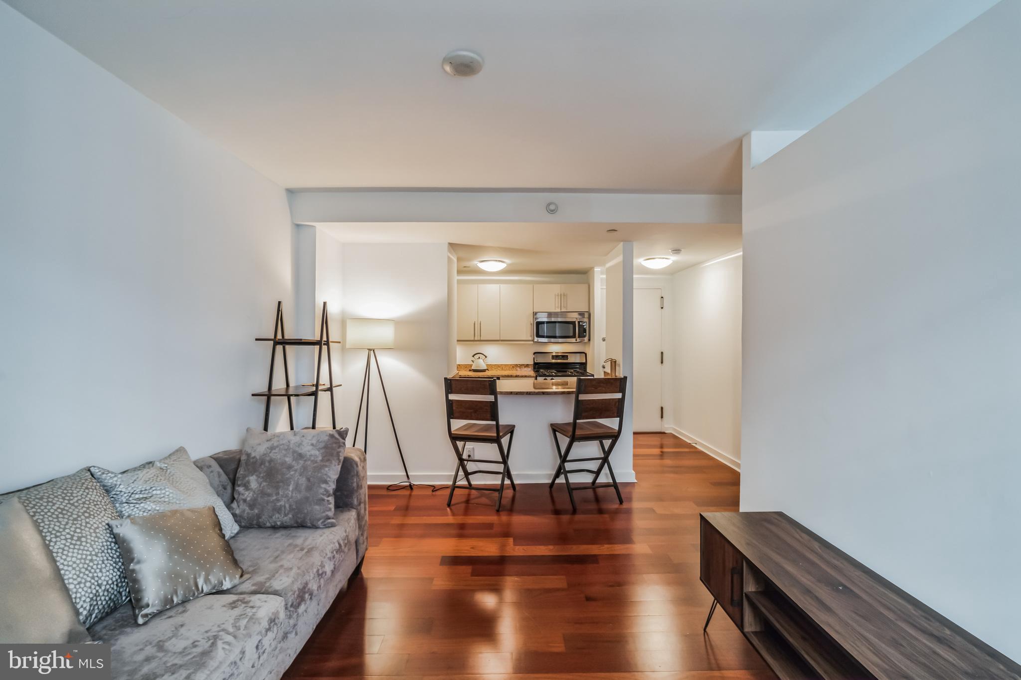 219 South 18th Street, Unit 1105 Philadelphia, PA 19103 - Photo 5 of 15 a living room with furniture and wooden floor