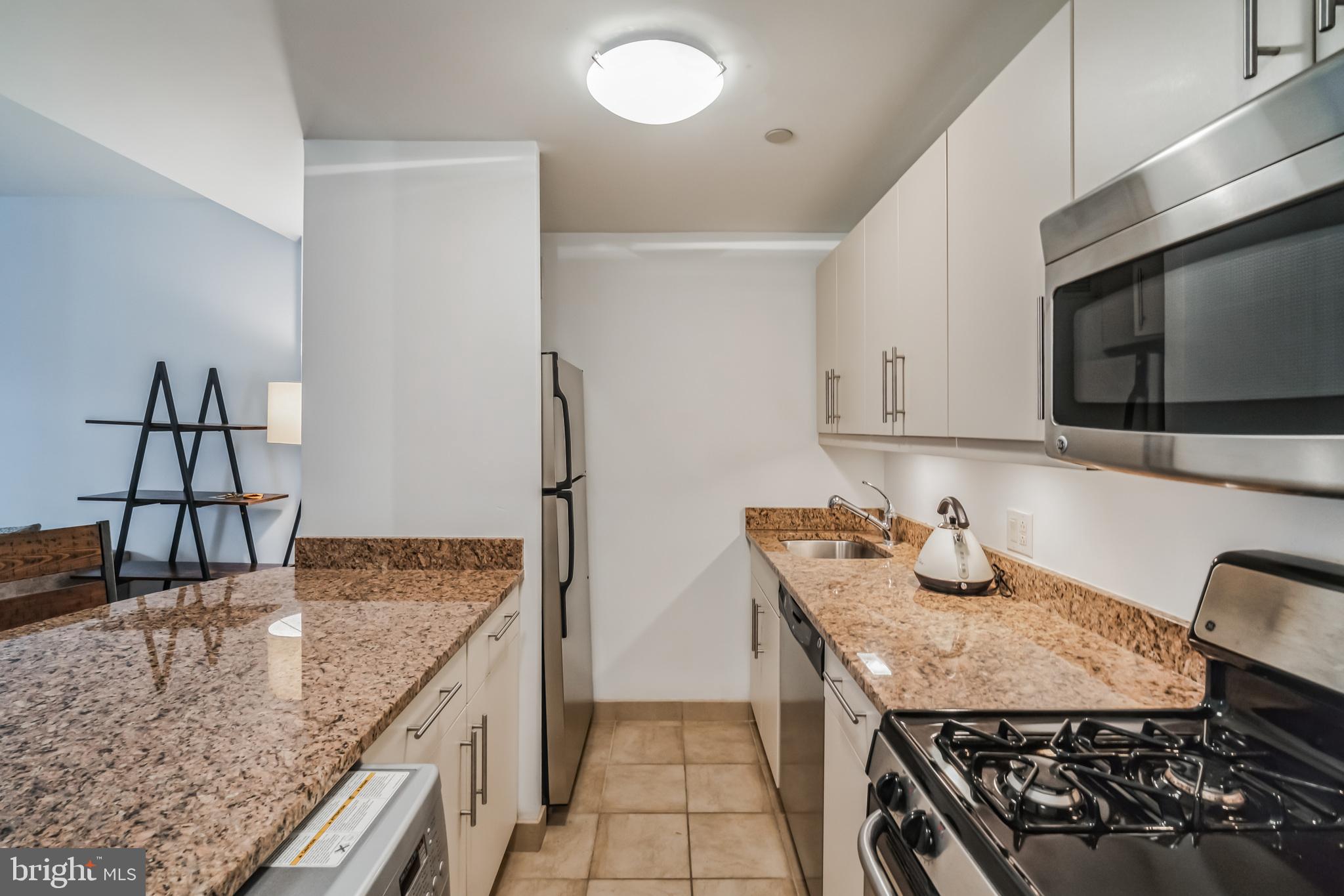 219 South 18th Street, Unit 1105 Philadelphia, PA 19103 - Photo 7 of 15 a kitchen with stainless steel appliances granite countertop a sink and a stove