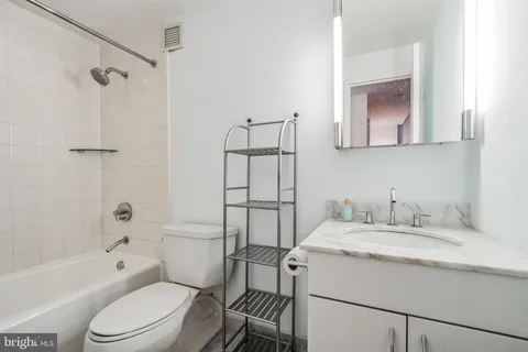 a bathroom with a sink toilet vanity and shower