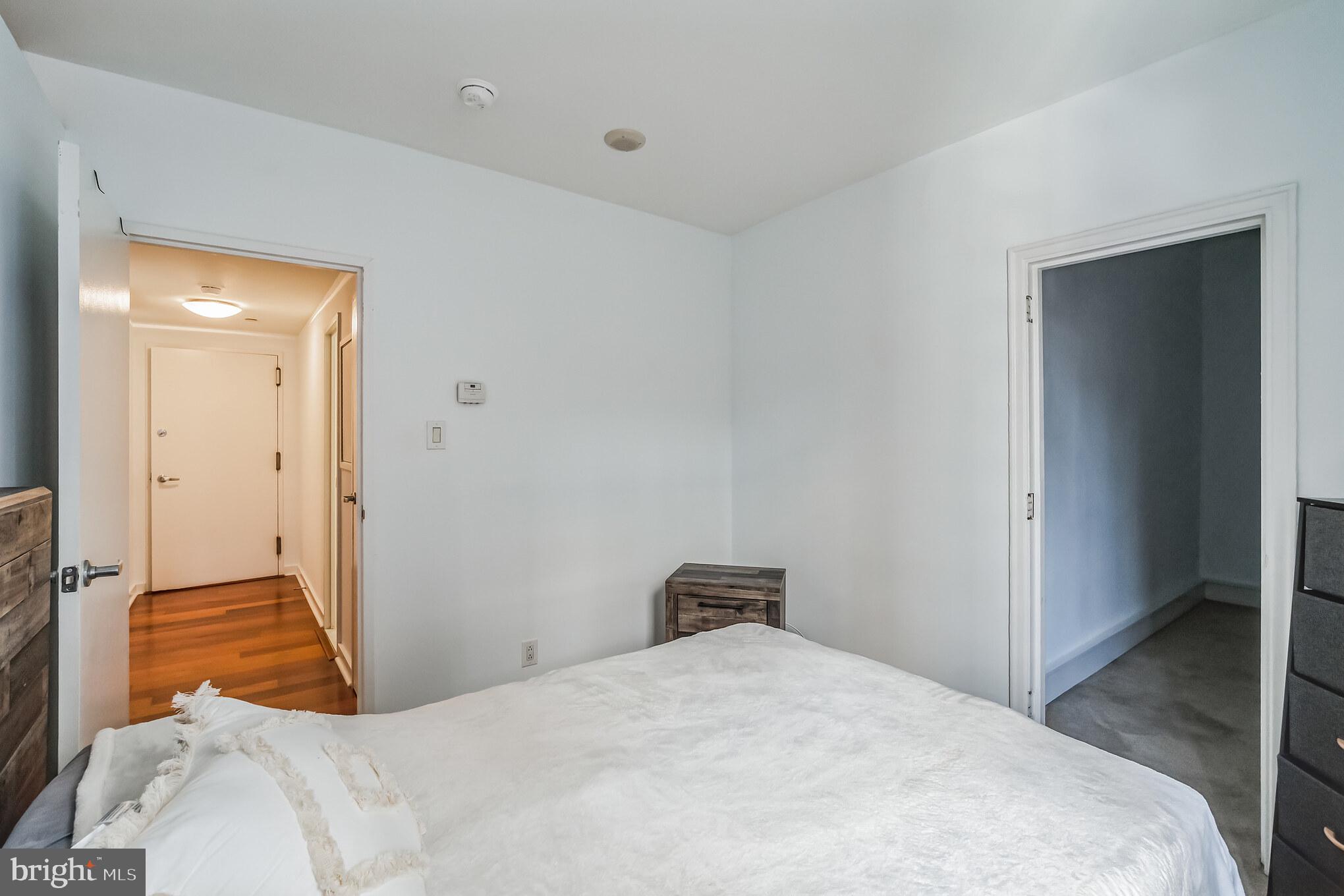 219 South 18th Street, Unit 1105 Philadelphia, PA 19103 - Photo 9 of 15 a bedroom with a bed and wooden floor