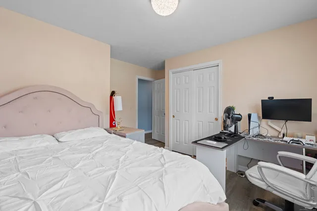 a bedroom with a bed and a desk