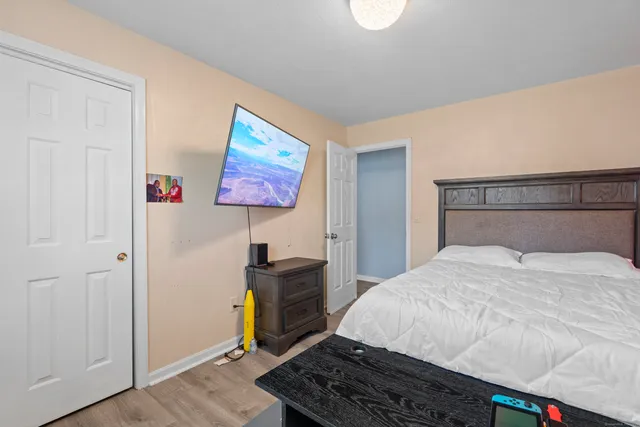 a bedroom with a bed and dresser