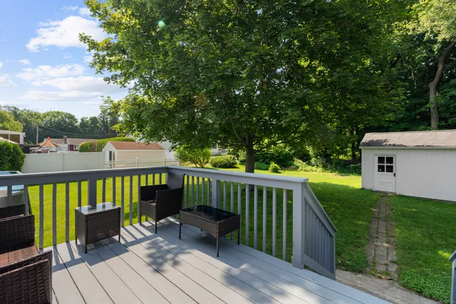 a view of a house with a backyard and a patio