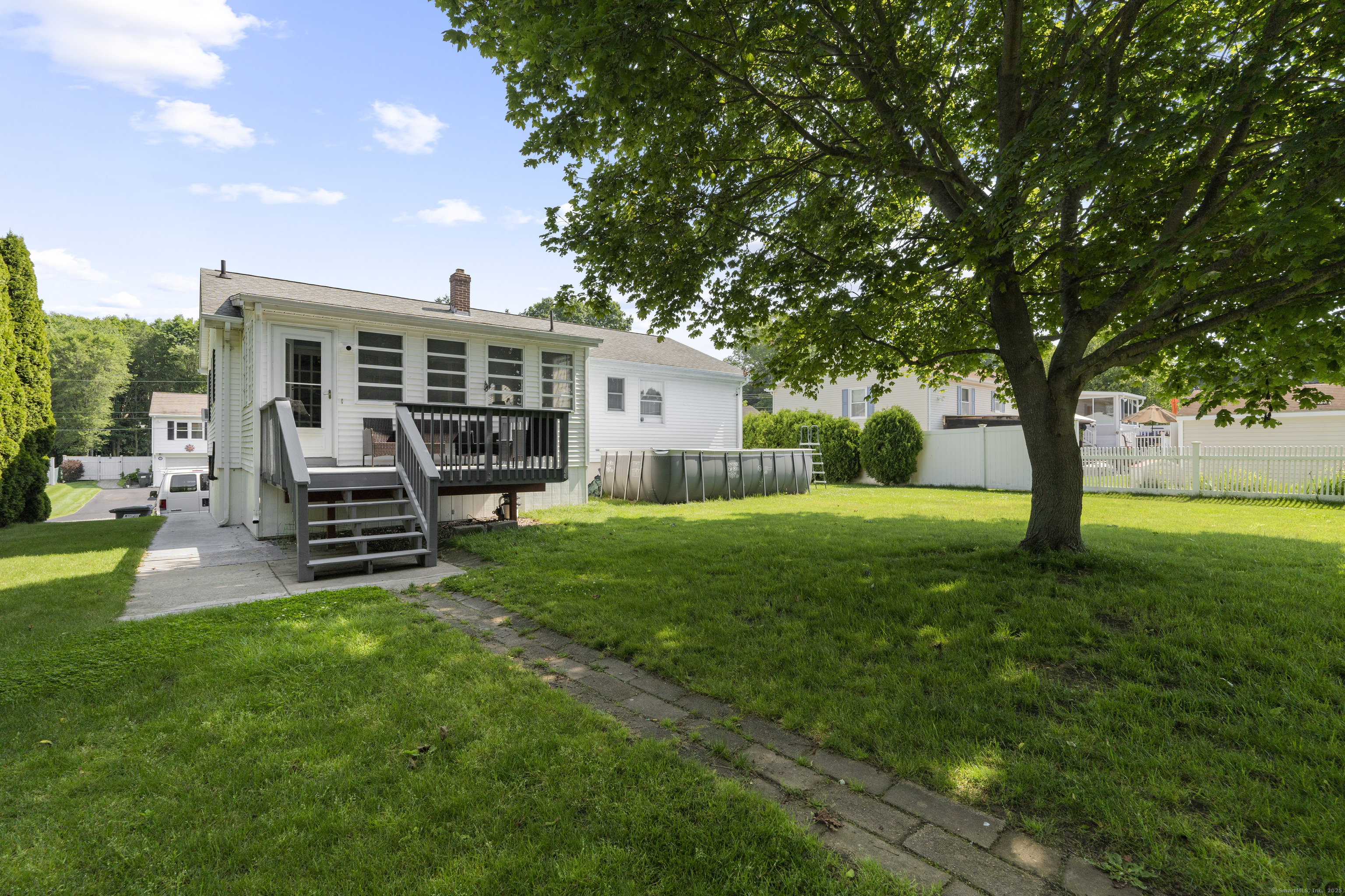 63 Johl Drive Groton, CT 06340 - Photo 29 of 40 a view of a house with a backyard and a patio