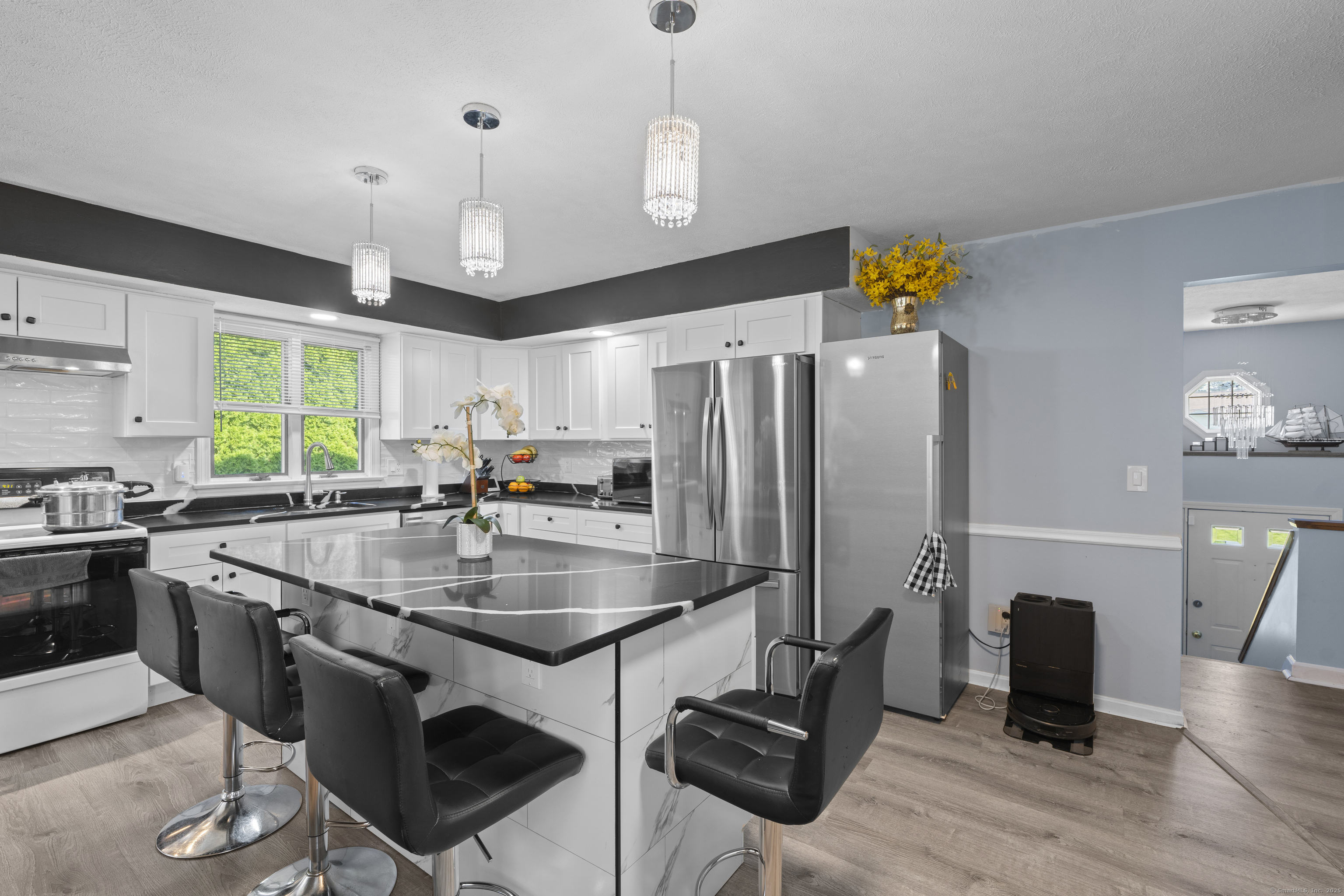 63 Johl Drive Groton, CT 06340 - Photo 3 of 40 a kitchen with stainless steel appliances granite countertop a sink a stove and a refrigerator
